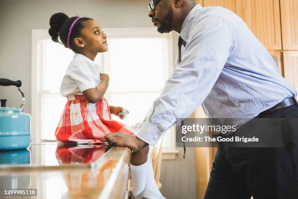 side view of father and daughter talking in kitchen during morning - girls in plaid skirts stock pictures, royalty-free photos & images