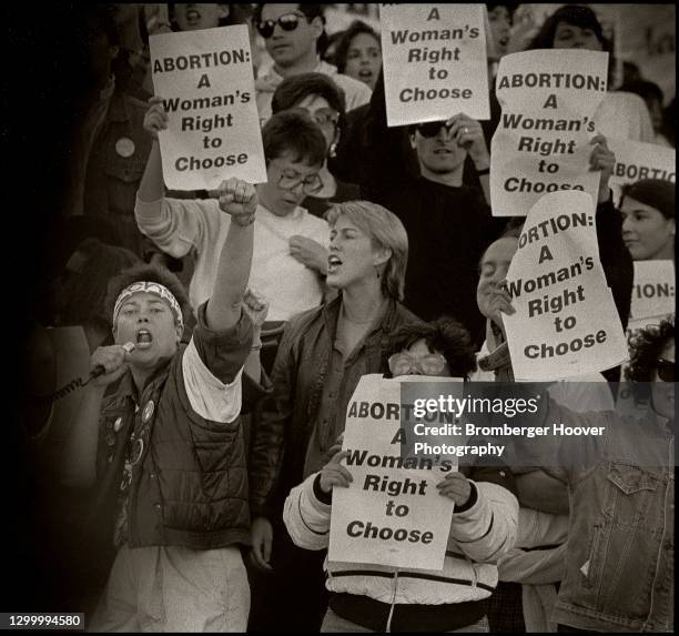 View of a group of demonstrators, many with signs, during a pro-choice rally, San Francisco, California, 1989. The signs read 'Abortion: A Woman's...