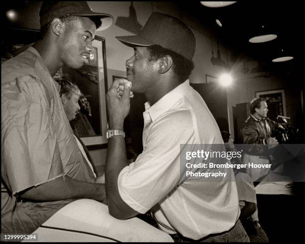 View of American baseball player Ken Griffey Jr as he talks with his father, fellow player Ken Griffey Sr during a press conference, Seattle,...