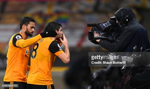 Ruben Neves of Wolverhampton Wanderers celebrates with team mate Willian Jose after scoring their side's first goal from the penalty spot during the...
