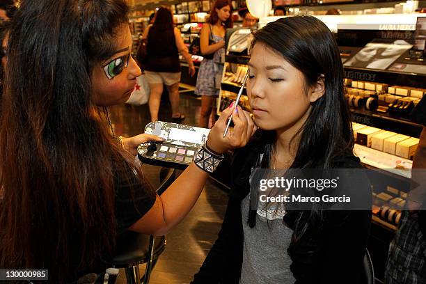 Make up artist Linee Aragon applies Tokidoki product on Leigh Yonemoto during a Tokidoki event at Sephora at the Ala Moana Center on October 22, 2011...