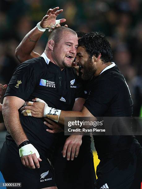 Tony Woodcock of the All Blacks celebrates scoring their first try with team mate Piri Weepu during the 2011 IRB Rugby World Cup Final match between...