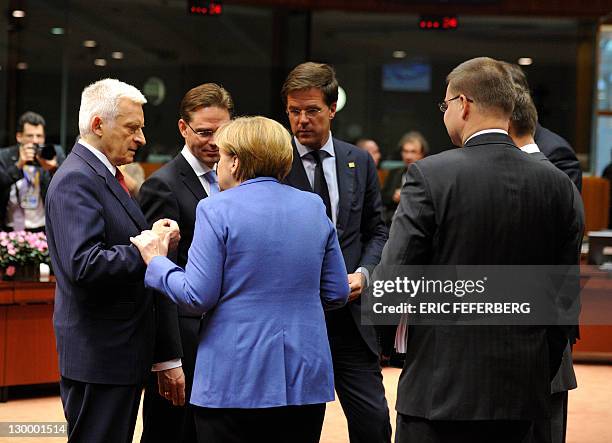 German Chancellor Angela Merkel talks with European Parliament President Jerzy Buzek, Finnish Prime Minister Jyrki Kaitanen and Dutch Prime Minister...