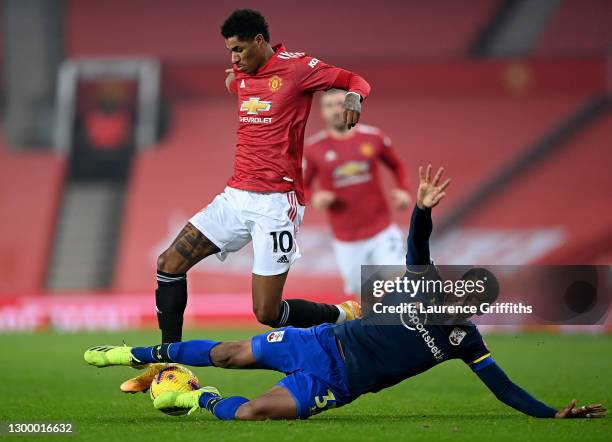 Kayne Ramsay of Southampton tackles Marcus Rashford of Manchester United during the Premier League match between Manchester United and Southampton at...