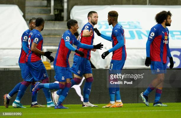 Gary Cahill of Crystal Palace celebrates with team mate Wilfried Zaha after scoring their side's second goal during the Premier League match between...