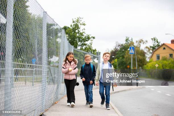 children walking together - school boy with bag stock pictures, royalty-free photos & images