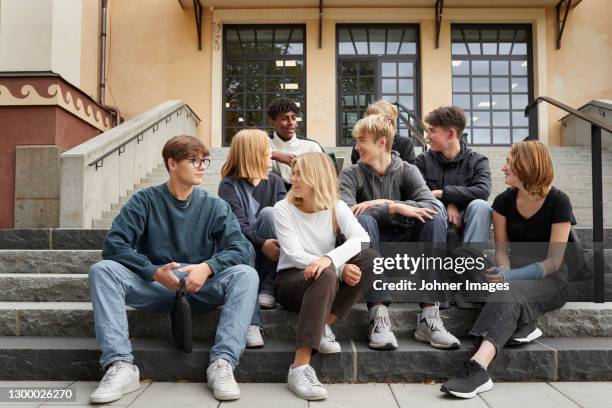 teenagers in front of school - skolgård bildbanksfoton och bilder