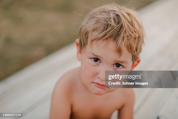 sulking boy looking at camera - baby pout stock pictures, royalty-free photos & images