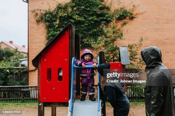 toddler girl standing on top of slide - kid sliding stock pictures, royalty-free photos & images