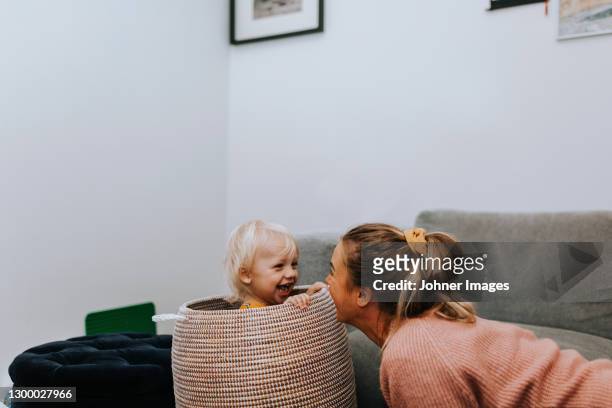 happy toddler boy sitting in basket - västra götaland county stock pictures, royalty-free photos & images