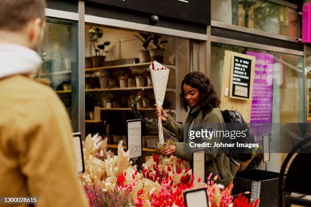 woman buying flowers - norrkoping stock pictures, royalty-free photos & images