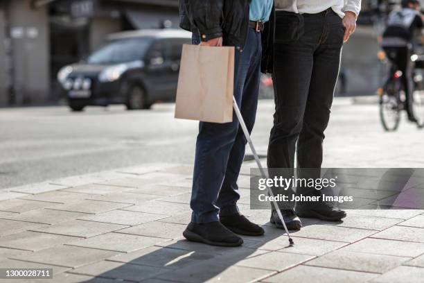 low angle view of couple standing - 白杖 ストックフォトと画像