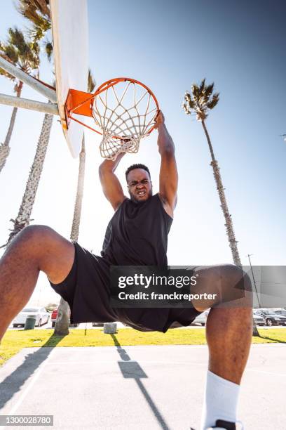 slam dunk in the street court - closeup basketball dunk stock pictures, royalty-free photos & images