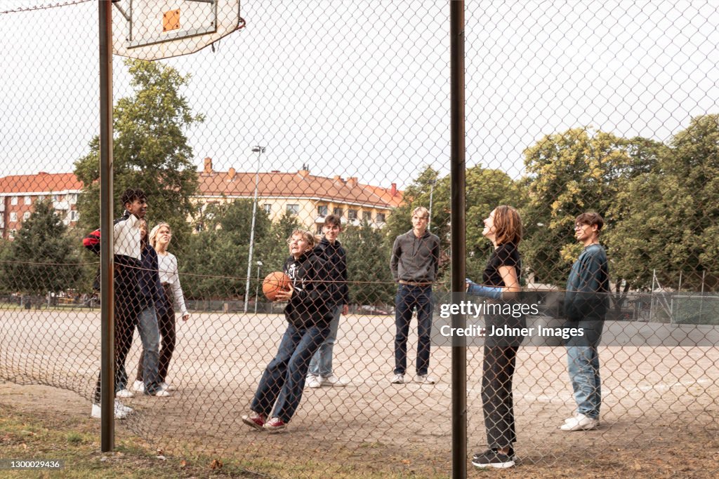Teenagers playing basketball