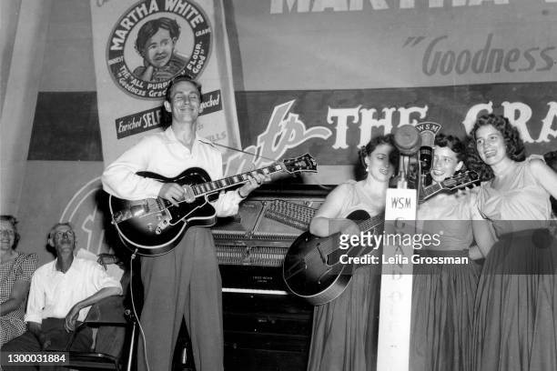 Country singer songwriter Chet Atkins performs with the Carter Family on stage at the Grand Ole Opry 1951 in Nashville, Tennessee.