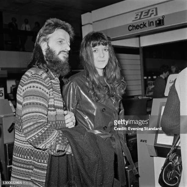 English drummer Ringo Starr of the Beatles with his wife Maureen Starkey at the BEA check-in desk of Heathrow Airport, London, UK, 28th February 1972.