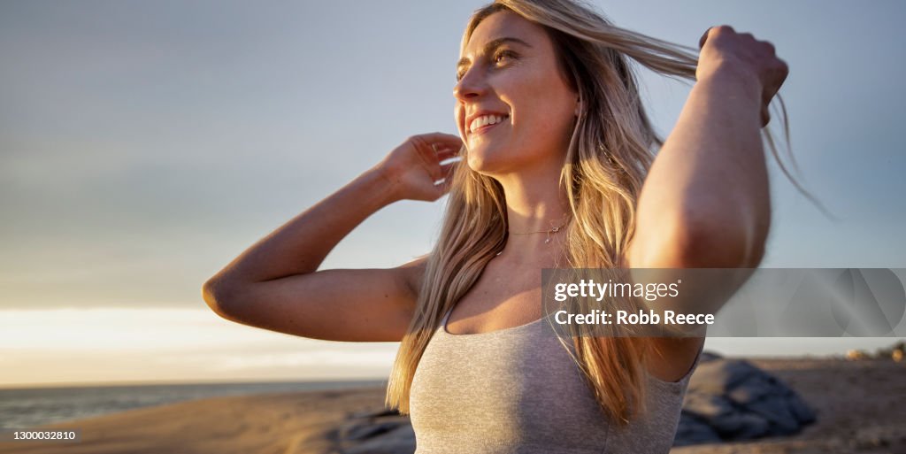Beautiful, Fit Woman Practicing Yoga On Rocky Beach