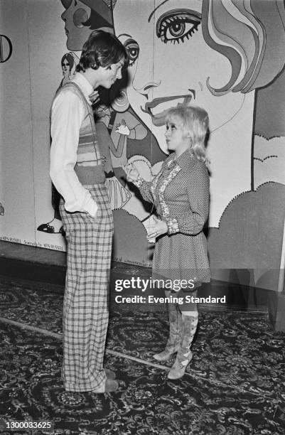 English actress Barbara Windsor chats with American actor and singer Tommy Tune at a press reception for the musical comedy film 'The Boy Friend' at...