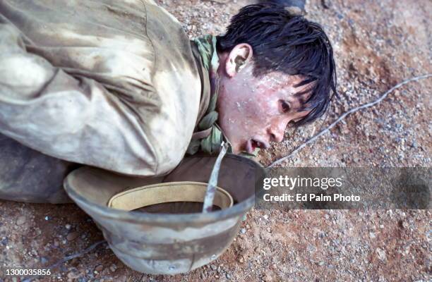 Main Force Viet Cong soldier taken prisoner by U.S. Marines on December 4 and awaiting interrogation in Cam Hieu village, Quang Tri Province, Vietnam.