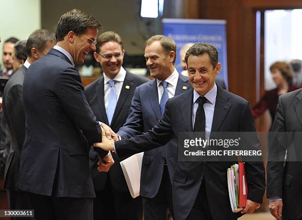 French President Nicolas Sarkozy chats with Dutch Prime Minister Mark Rutte during a tour-de-table before the European Council at the Justus Lipsius...