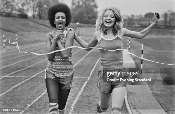 Two models on the track in sports shorts and vests, UK, 11th May 1972.