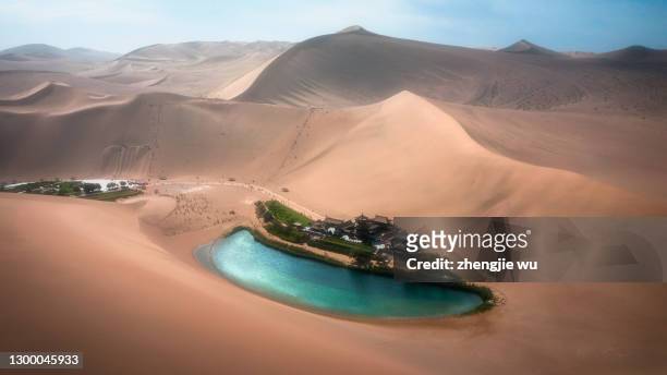 crescent lake with buddhist temple in kumtag desert, dunhuang, gansu china ,the singing sand hill - mogao caves stock pictures, royalty-free photos & images