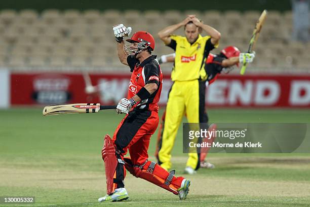 Callum Ferguson of the Redbacks celebrates as Nathan Rimmington of the Lions reacts after the Ryobi One Day Cup match between the South Australia...