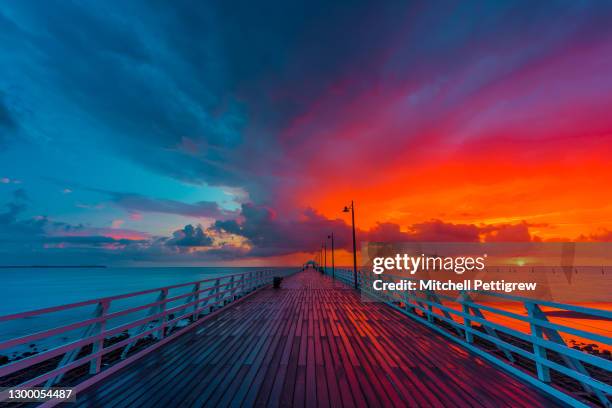 shorncliffe pier sunrise - brisbane beach stock pictures, royalty-free photos & images