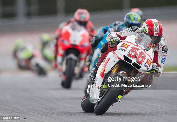 Marco Simoncelli of Italy and San Carlo Honda Gresini leads the field during the MotoGP race of MotoGP of Malaysia at Sepang Circuit on October 23,...