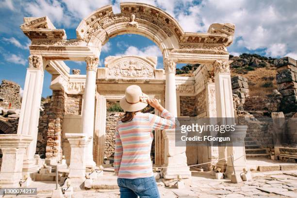 young woman visiting temple of hadrian in ephesus ancient city - kusadasi stock pictures, royalty-free photos & images