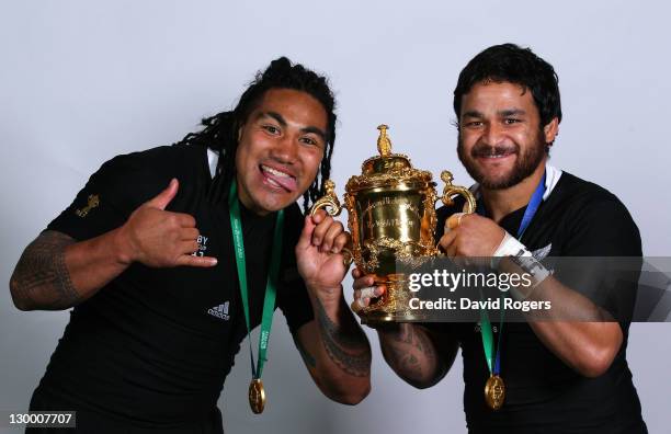 All Black centre Ma'a Nonu and scrumhalf Piri Weepu pose with the Webb Ellis Cup following their team's 8-7 victory during the 2011 IRB Rugby World...