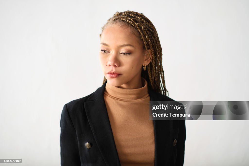 Young businesswoman headshot portrait looking down.