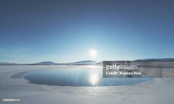 circular hole in the ice lake - gefrorener see stock-fotos und bilder