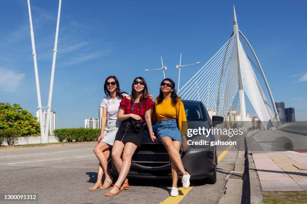 vrienden op de zitting van de reis van de weg op kap van auto - putrajaya stockfoto's en -beelden