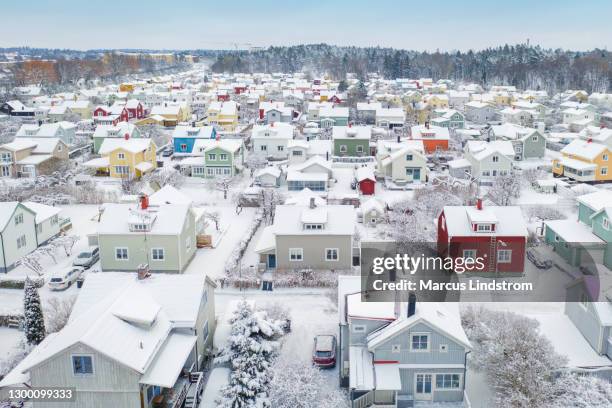 rows of snow covered houses in winter in sweden - sweden winter stock pictures, royalty-free photos & images