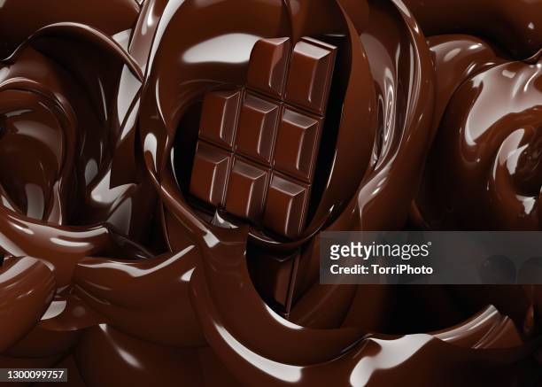 dark chocolate bar dip in melted chocolate - chocolate stock pictures, royalty-free photos & images