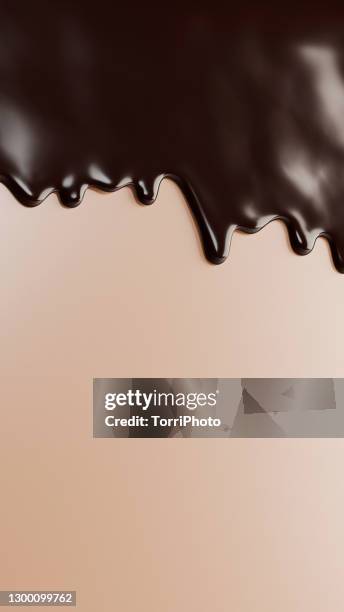 glossy brown drips flow down over beige background - chocolate liquido fotografías e imágenes de stock