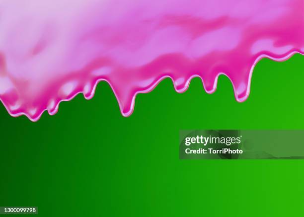 glossy pink slime or paint on vivid green background - slime stockfoto's en -beelden