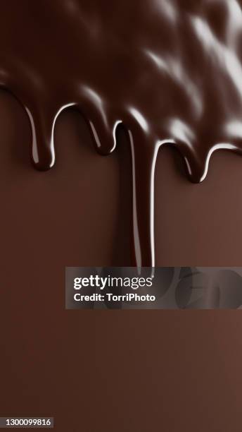 melted chocolate drips over brown background - chocolate stockfoto's en -beelden