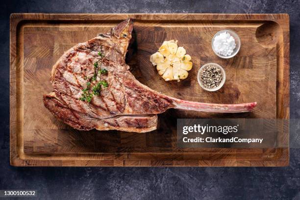 barbecued tomahawk steak. - bone in rib steak stock pictures, royalty-free photos & images
