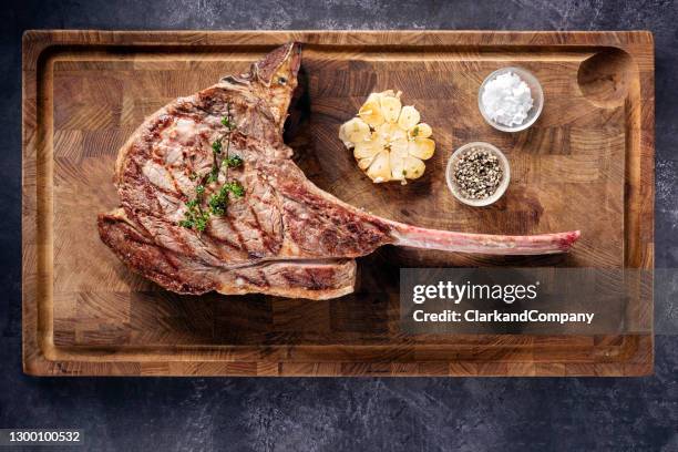 barbecued tomahawk steak. - tomahawk stock pictures, royalty-free photos & images