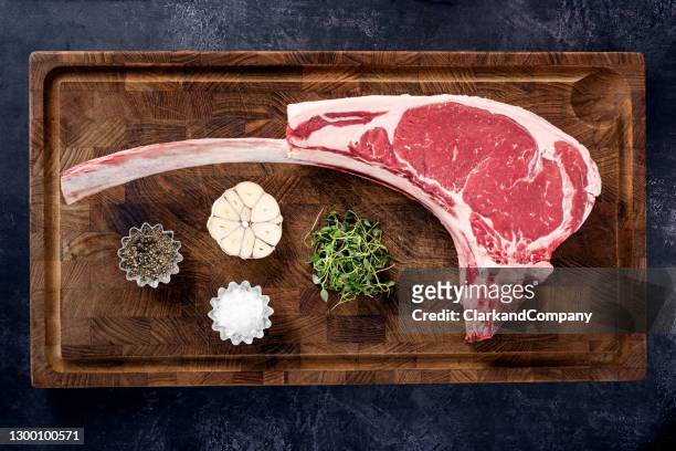 preparing a tomahawk steak for cooking - tomahawk stock pictures, royalty-free photos & images