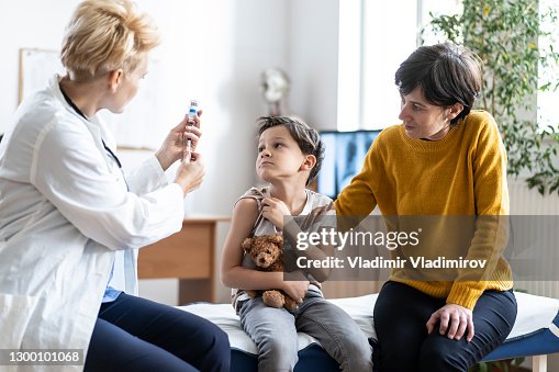 Little Boy Getting Vaccinated at the Pediatrician's Office Little Boy Getting Vaccinated at the Pediatrician's Office