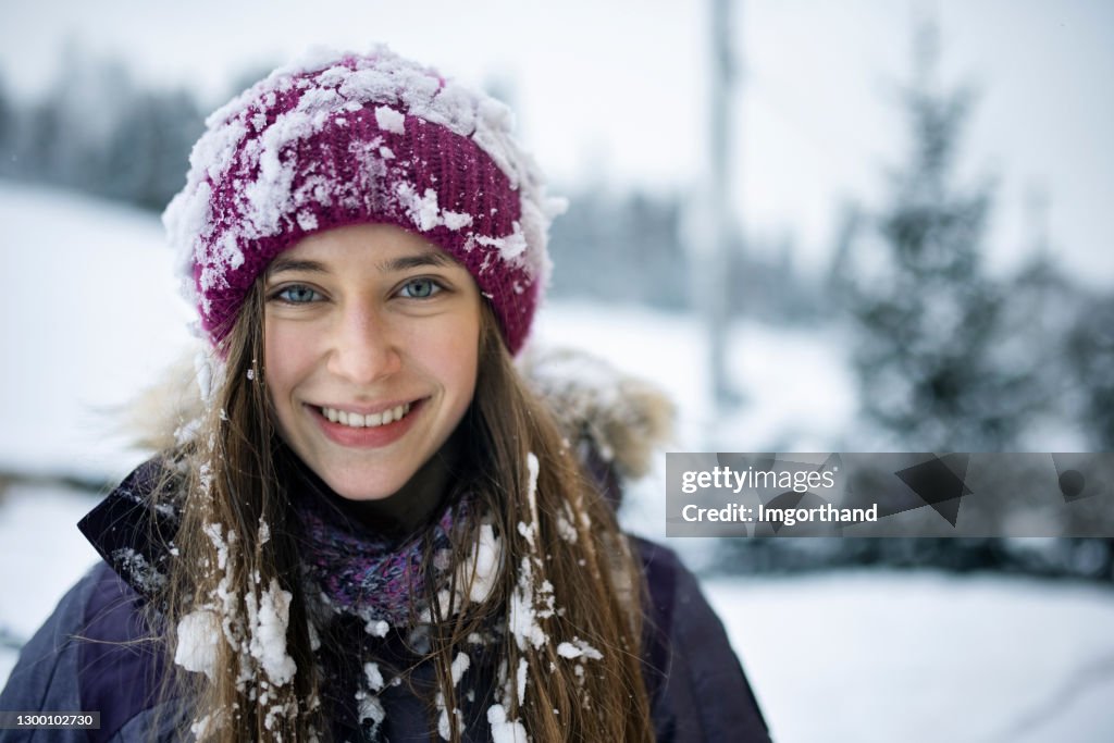 Portrait of a teenage girl playing on winter day