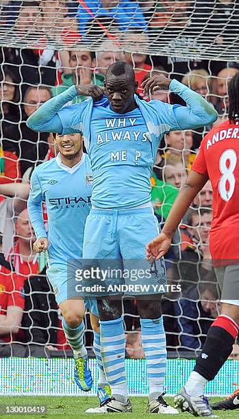 Manchester City's Italian striker Mario Balotelli celebrates scoring the opening goal of the English Premier League football match between Manchester...