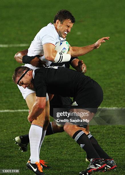 Damien Traille of France is tackled by Brad Thorn of the All Blacks during the 2011 IRB Rugby World Cup Final match between France and New Zealand at...