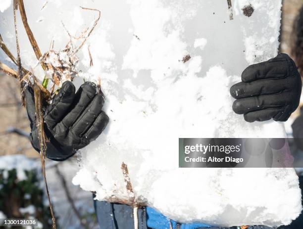 a person with gloves holds a large block of ice. - frostbite fingers stock pictures, royalty-free photos & images