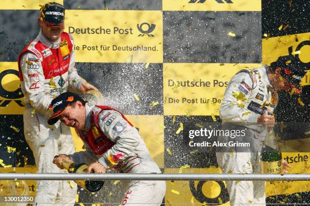 Martin Tomczyk of Germany and Audi Sport Team Phoenix celebrates winning the DTM German Touring Car Championship with second placed Mattias Ekstrom...