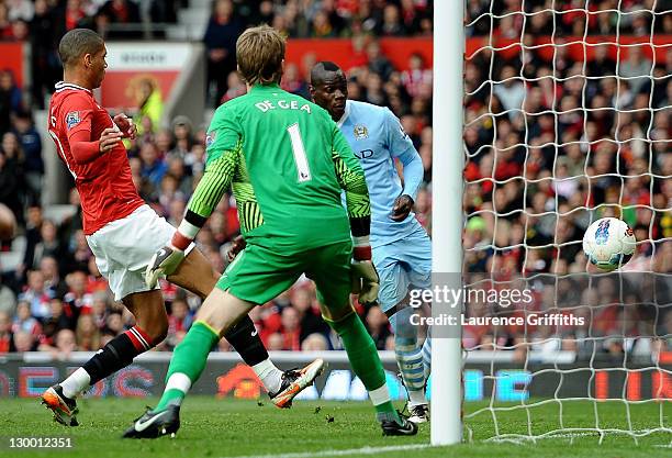 Mario Balotelli of Manchester City scores his team's second goal during the Barclays Premier League match between Manchester United and Manchester...