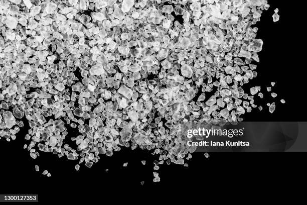 sea salt seasoning on black background isolated. bath salt for scrubbing and cleansing skin. exfoliation scrubber. cosmetic products for skin care. beauty spa. - bath salt stock pictures, royalty-free photos & images
